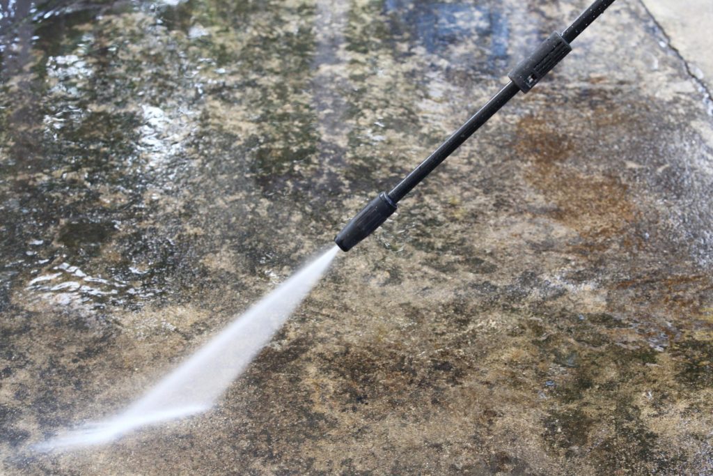 water pressure cleaning the concrete flooring