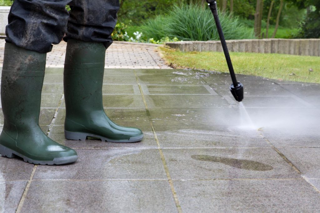 cleaning the patio using water pressure